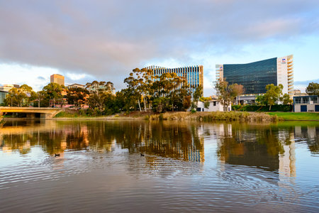 Adelaide,  Australia - August 27, 2017: University of Adelaide and UniSA buildings viewed across Torrens river at sunsetのeditorial素材