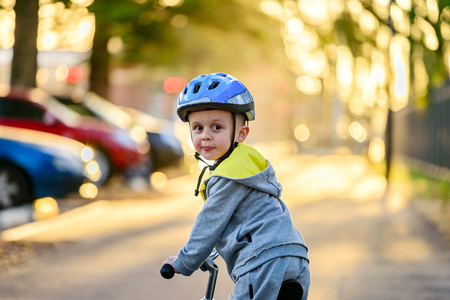 Cute australian child riding his bicycle and wearing helmet on a day in Glenelg, South Australiaの写真素材