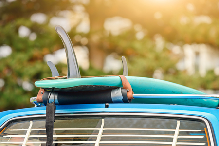 Surfboard on roof rack of vintage car, South Australiaの写真素材