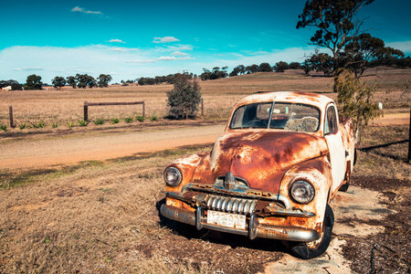 Kapunda, South Australia - June 17, 2017: Old rusty Holden FJ Ute near local farm entrance viewed...