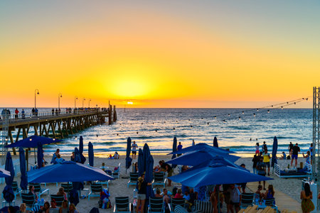 Adelaide, South Australia - March 11, 2018: People at The Moseley Beach Club cafe enjoying sunset view on a summer eveningのeditorial素材