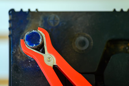Close-up veiw of charging an old car battery, red clamp on positive sideの写真素材
