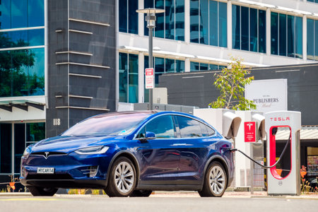 Adelaide CBD, Australia - November 18, 2017: Tesla Model X car and Tesla Supercharger EV charging station in city centre on Franklin Street on a dayのeditorial素材
