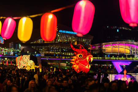 Adelaide, Australia - October 19, 2019: Hong Kong Dragon head carried through crowd of people  during Moon Lantern Festival celebration in Elder Park at nightのeditorial素材