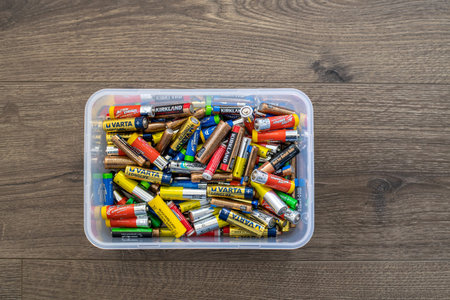 Adelaide, Australia - July 7, 2019: Assortment of used household AA and AAA batteries collected in...