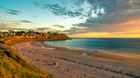 Adelaide, South Australia - October 7, 2018: People walking along the shore while enjoying beautiful sunset at Christies Beach on a warm eveningのeditorial素材