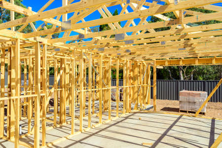 New Australian house construction site with timber frame installed and ready for bricklaying on bright summer dayの写真素材