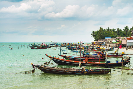Koh Samui, Thailand - January 2, 2020: Thai long tail fishing boats docked near Thong Krut beach on a dayのeditorial素材