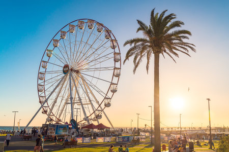 Adelaide, South Australia - January 12, 2019: Glenelg Mix102.3 Giant Ferris Wheel viewed from the Moseley Square on a bright summer dayのeditorial素材