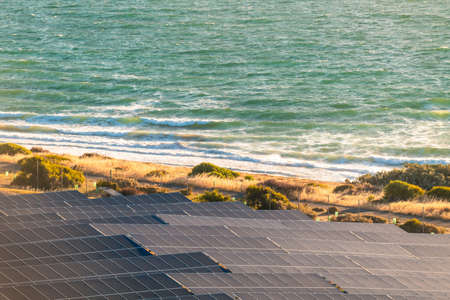 Solar panels installed along the sea shore at sunset in South Australiaの写真素材