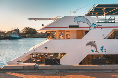 Port Adelaide, Australia - September 9, 2020: Dolphin Explorer ferry moored at the docks after Port River cruise at sunset timeのeditorial素材