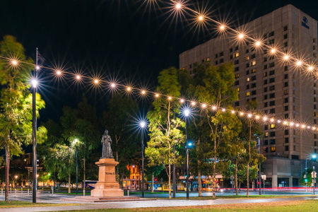 Adelaide, South Australia - January 2, 2022: Victoria Square with Queen Victoria monument illuminated at night time in Adelaide CBD viewed towards King William street.のeditorial素材