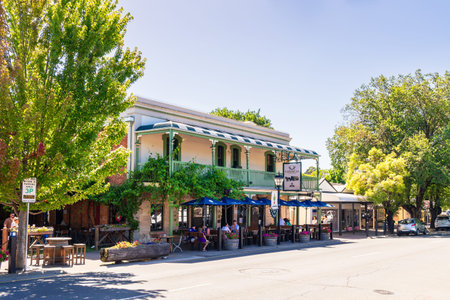 Hahndorf, Adelaide Hills, South Australia - January 9, 2023: The Hahndorf Inn German restaurant with people sitting outside viewed from the Main street on a bright dayのeditorial素材