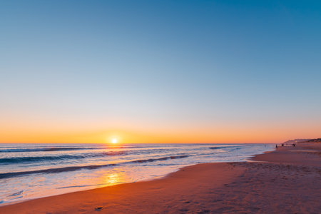Port Noarlunga beach with fishermen at sunset, South Australiaの写真素材