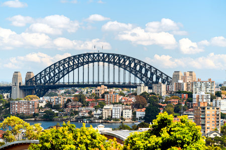 Sydney Harbour Bridge among Sydney North residential buildings in the background viewed from Bradleys Head on a dayの写真素材