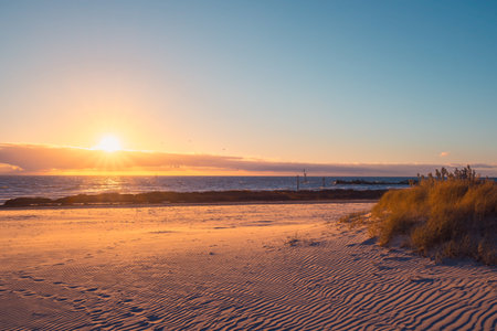 Dramatic sunset with clouds above the sea at Glenelg beach, Holdfast Bay, South Australiaの写真素材