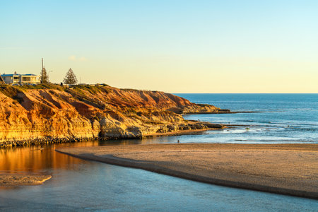 Onkaparinga River mouth with people walking around at sunset, South Port Beach, South Australiaの写真素材