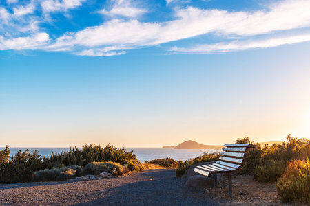 Bench with ocean views on Granite Island at sunset, Victor Harbor, South Australiaの写真素材
