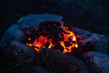 Camp fire outdoors burning coalの写真素材