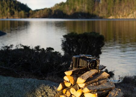 Analog film camera on a pile of woodの写真素材