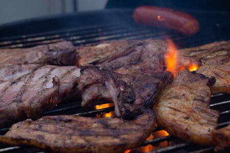 Barbecuing meat on a grillの写真素材