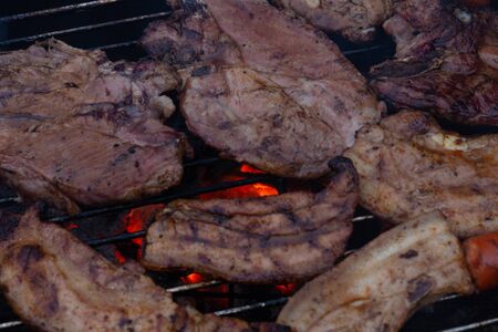Barbecuing meat on a grillの写真素材