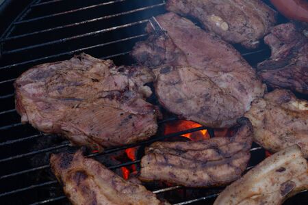 Barbecuing meat on a grillの写真素材