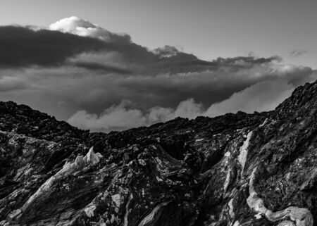 Dramatic clouds with cliffs that's been shaped by the seaの写真素材
