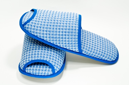 Pair of house slippers with reflection on white backgroundの写真素材