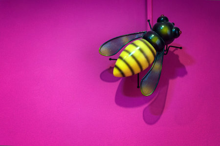 Bee Doll orange. On a pink background.