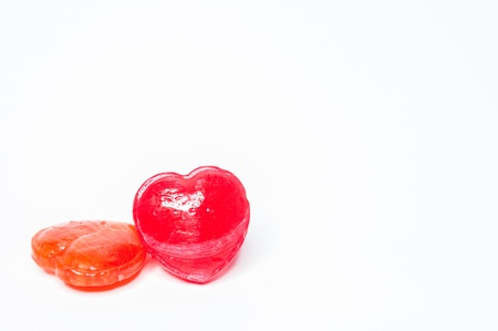 Red Heart shaped candy on a white background. .の写真素材