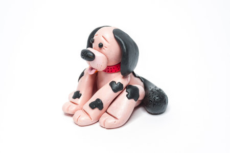 Dog sculpture with clay streaked with black dots.の写真素材