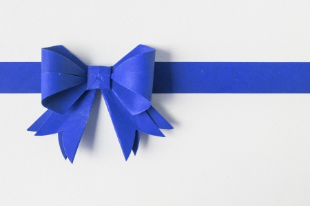 Blue ribbon on white recycled paper. Paper craft .の写真素材