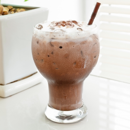 Chocolate smoothie in glass on white background.の写真素材