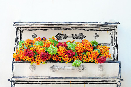 Plastic flower in flowerpot the side of a wall.の写真素材