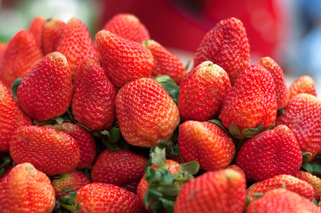 Many Strawberry of the bright red with green leaves.の写真素材