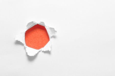 Torn white paper in a circle Inside the orange circle.の写真素材