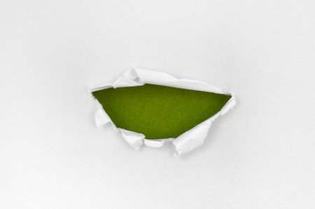 White paper torn semicircle shape beautiful. Beautiful green backgroundの写真素材