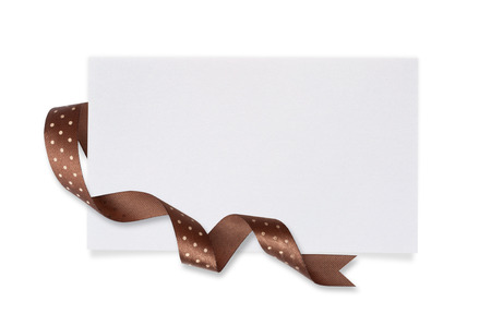 White paper card with a Brown bow on a white background.の写真素材