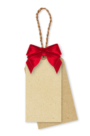 Brown Paper tag, rope and red ribbon bow on white background.の写真素材