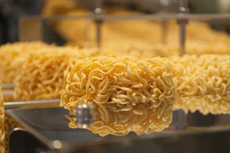 Noodles yellow in manufacturing belt.の写真素材