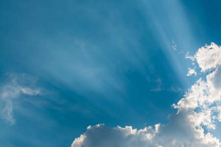 Blue sky with sun ray slipping through cloud. Abstract Background.の写真素材