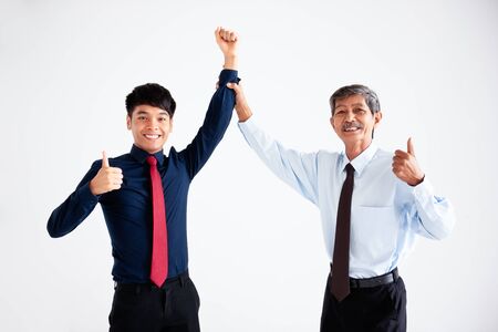 Two businessmen are standing with smiling and thumbs them up after their business success deals. Photo on white background. isolated.の写真素材