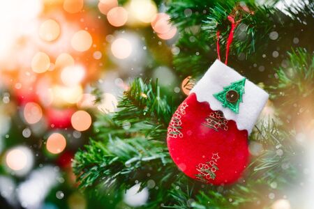 Christmas tree with decorations bokeh blurred glow. Happy New Year and Merry x-mas.の写真素材
