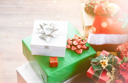 Three Christmas boxes with decoration gift on a floor with glow light. Happy new year and merry x-mas.の写真素材