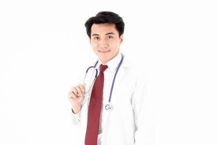 Close up portrait of the handsome young man smile doctor holding stethoscope look the camera on white background, isolated.の写真素材