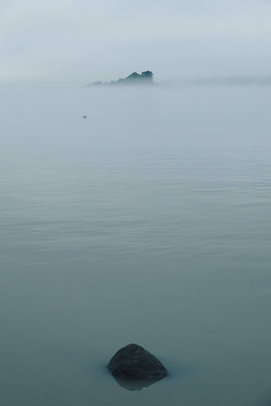 Misty Fog Envelops Pyramid Island on Calm Alaska Sea