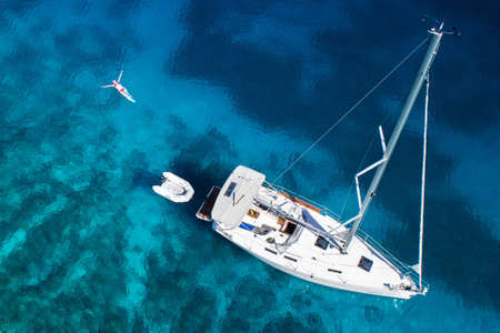 amazing view to yacht, swimming woman and clear water - caribbean paradiseのeditorial素材