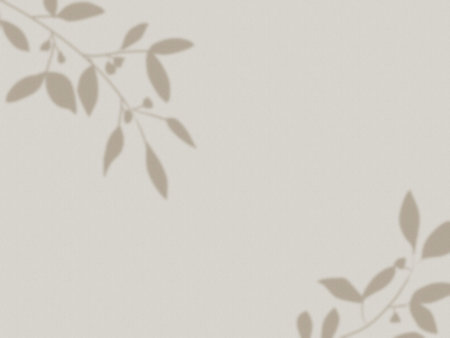 Beige wall background with shadows of branches and leaves
