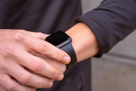Sportsman looking at smartwatch with blank screen